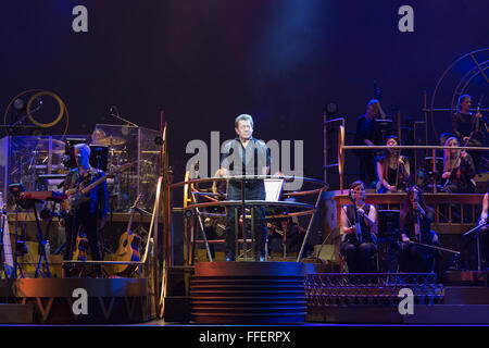 London, UK. 12 February 2016. Jeff Wayne conducting. Bill Kenwright and Jeff Wayne present Jeff Wayne's Musical Version of The War of the Worlds based on the classic science fiction story by HG Wells at the Dominion Theatre. Performances run from 9 February 2016. With David Essex as The Voice of Humanity, Jimmy Nail as Parson Nathaniel, Daniel Bedingfield as The Artilleryman, Michael Praed as the Journalist George Herbert, Heidi Range, Madalena Alberto as Carrie with Liam Neeson as The Journalist on screen. Credit:  Vibrant Pictures/Alamy Live News Stock Photo