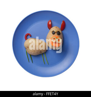 Pig made of vegetables on blue plate Stock Photo