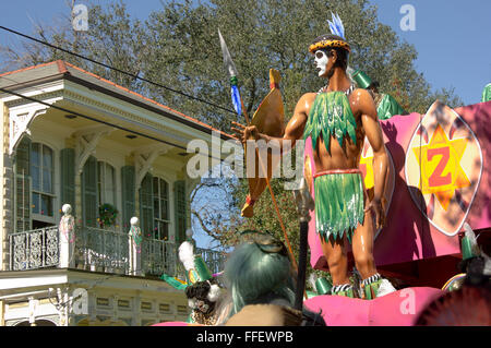 A Zulu float passing by a Victorian shotgun home on Mardi Gras day in New Orleans. Stock Photo