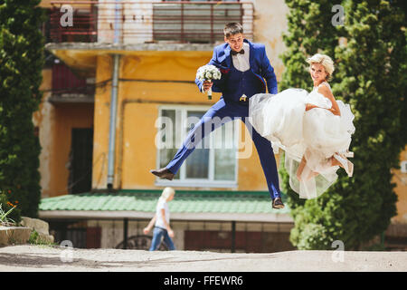 couple jumping on the street Stock Photo
