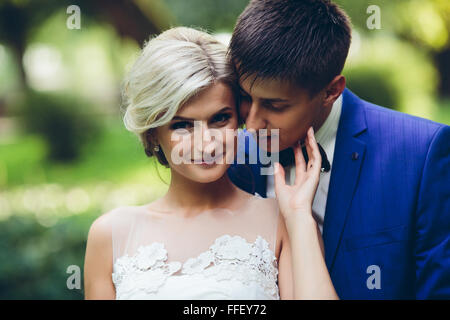 Beautiful wedding couple posing in the park Stock Photo