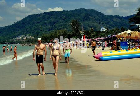 Phuket, Thailand: Tourists strolling along pristine Patong Beach with its white sand on the Andaman Sea Stock Photo