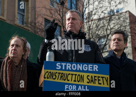 New York, United States. 12th Feb, 2016. Mayor de Blasio speaks to the press at a briefing on East 8th Street. Accompanied by a cadre of City officials including Department of Buildings Commissioner Rick Chandler, Mayor Bill de Blasio spoke at a press conference in Manhattan's East Village to announce a series of construction regulation reforms including new on-site safety requirements and steep increase in fines for building code violations, in New York City. © Albin Lohr-Jones/Pacific Press/Alamy Live News Stock Photo