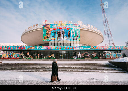 Gomel, Belarus - January 23, 2016: Unidentified woman walking near Gomel State Circus in snowy winter day. Stock Photo