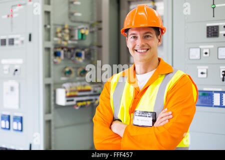 happy electrical engineer standing in control room Stock Photo