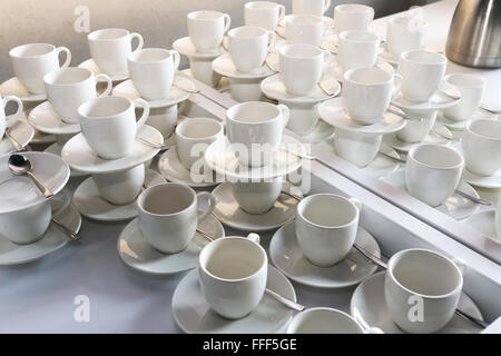 Pure white cups and saucers in rows Stock Photo