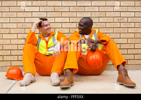 happy power company co-workers chatting during break Stock Photo
