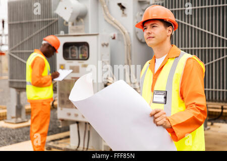 thoughtful electrical engineer in electric substation Stock Photo