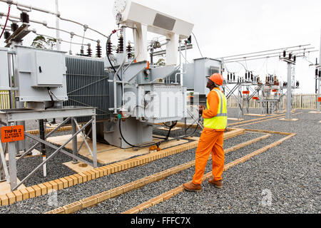 professional African electrician working in electrical substation Stock Photo