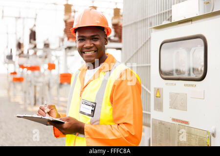 senior technician holding clipboard in substation Stock Photo