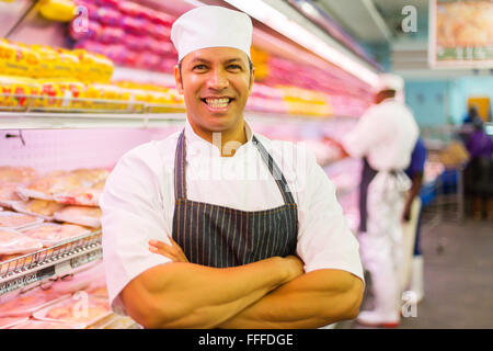 happy mature butcher in butchery Stock Photo