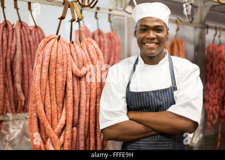 portrait of young African butcher arms crossed in storage Stock Photo