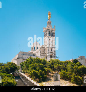 Catholic Basilica of Our Lady of the Guard or Notre Dame De La Garde church at hill in Marseille, France. Sunny summer sky. Stock Photo