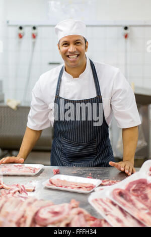 handsome middle aged man working in butcher-shop Stock Photo