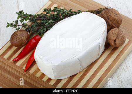 Brie cheese with thyme leaves and nuts Stock Photo