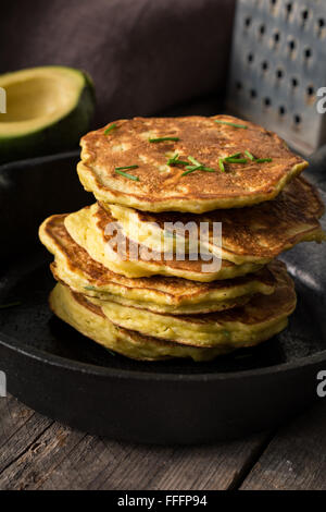 Stack of homemade savory vegetable pancakes / cabbage pancakes / zucchini pancakes / vegetable fritters with cheese. Stock Photo