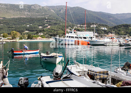 Lone Greek fisherman prepares to go fishing in the Ionian Sea at Valtos Beach Harbour, Greece. Stock Photo