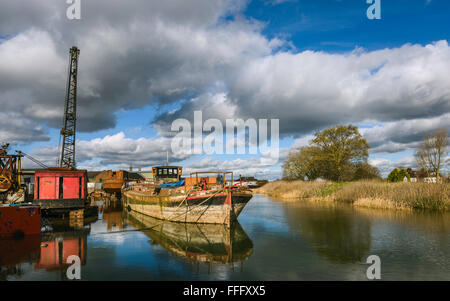 Dereliction including rusting iron river boats and machinery on the river Hull on a bright sunny morning in winter in Beverley. Stock Photo