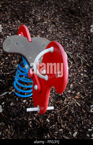 Children's spring rocking ride in a play park standing empty Stock Photo