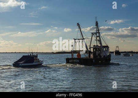 Fishing Boat Towing Smaller Craft in to Old Leigh Stock Photo