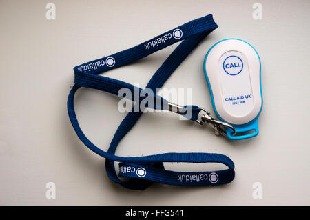 Call Aid UK Call / Panic Button as pendant on a lanyard. Used by the elderly or house bound to call for help or in event of fall Stock Photo