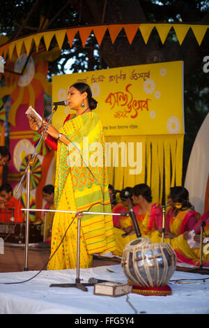 Dhaka, Bangladesh. 13th Feb, 2016. Bangladeshi women reading poem during the 'Basanta Utsab' or spring Festival in Dhaka in Dhaka, Bangladesh on February 13, 2016. The blazing red and yellow are the representative colours of Pohela Falgun. Pohela Falgun, the first day of spring in the Bengali month of Falgun, is being celebrated today with flowers, poems, songs and dances. It brings joys and colours both in nature and life. After the dryness of winter, new leaves start to come out again and the nature adorns the branches with new colorful flowers such as Shimul, Polash and Marigold. Especiall  Stock Photo