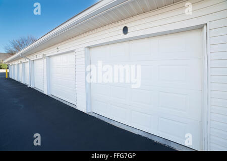 Row of garage doors at parking area for apartment homes Stock Photo