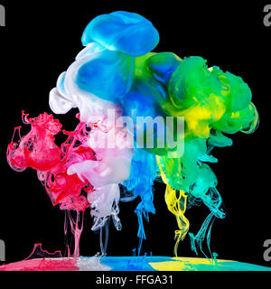 Colored inks in water on black background Stock Photo