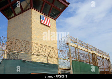 guantanamo bay cuba gtmo camp six entrance watchtower barbed wire fence american flag Stock Photo