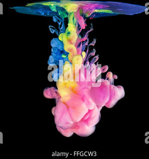 Colored inks in water on black background Stock Photo