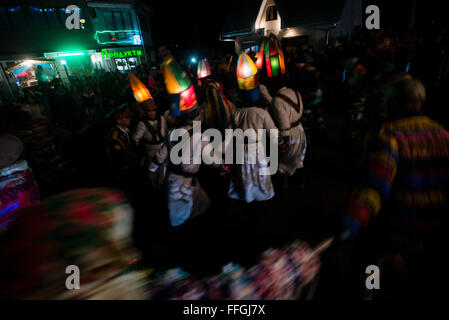 Koliadnyky - group of adult and kids dressed in costumes of soldiers and traditional Ukrainian female costumes - dance in a ring at the yard of the host house during Malanka celebration in Velykyj Kuchuriv village, Bukovina, Ukraine Stock Photo