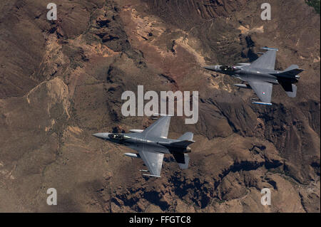F-16 Fighting Falcons from the 162nd Wing, Tucson, Arizona fly over an training range on April 8, 2015. The 161st Wing manages a fleet of more than 70 F-16 C/D and Mid-Life Update Fighting Falcons. There are three flying squadrons and numerous maintenance units assigned to the wing. Stock Photo