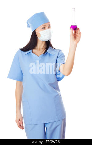 Full isolated studio picture from a young and beautiful female doctor with flask in her hand. Stock Photo