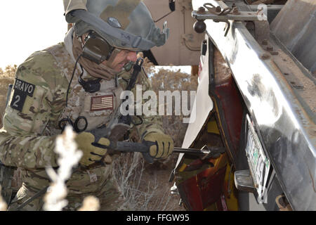 An Air Force Reserve pararescueman from the 304th Rescue Squadron pries open the doors of an overturned van as part of a patient extraction exercise in Riley, Ore. Stock Photo