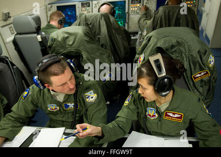 1st Lt. Ryan Smith and Christina Norbygaard, both air weapons officers from the 552nd Air Control Wing at Tinker Air Force Base, Okla., communicate enemy aircraft positions to allied combat aircraft during a Red Flag 12-2 air operations exercise aboard an E-3 Sentry AWACS near Nellis Air Force Base, Nev. Stock Photo