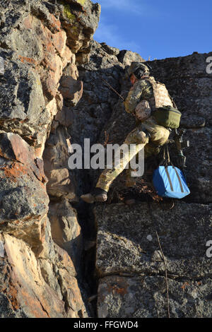 An Air Force Reserve pararescueman from the 304th Rescue Squadron descends the face of cliff to reach a patient during a simulated cliffside rescue mission in Riley, Ore. Stock Photo