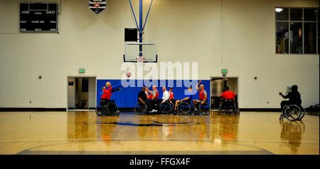 Wheelchair basketball athlete, retired Chief Master Sgt. Damian Orslene (left), makes a pass during practice at the Air Force team's Warrior Games selection camp. Stock Photo