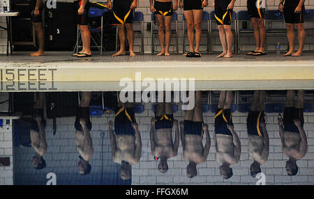 Special Operations Command team member, U.S. Air Force Tech. Sgt. Marc Esposito, far left, and other athletes stand at attention during a medal ceremony of the swimming competition. Stock Photo