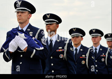 U.S. Air Force Airmen assigned to the Shaw Air Force Base Honor Guard, march in formation with a folded U.S. flag concluding a retreat ceremony  at Shaw Air Force Base, S.C. Shaw’s Honor Guard conducted the retreat ceremony at the end of the first day of Shaw’s Air Expo.