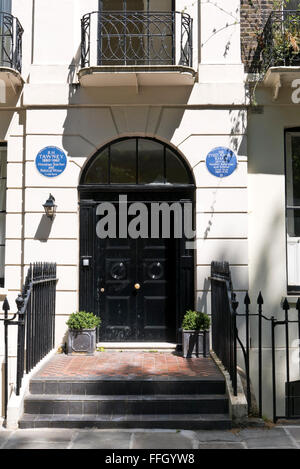 Two commemorative blue plaques with the names of R.H Tawney and Sir Syed Ahmed Khan on display on a wall in London, UK.