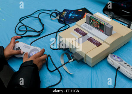 Child playing Donkey Kong Country on Super Nintendo Entertainment System - USA Stock Photo