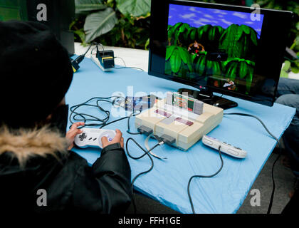 Child playing Donkey Kong Country on Super Nintendo Entertainment System - USA Stock Photo