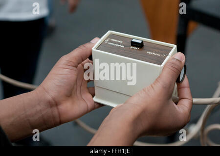Men playing video game using vintage game controller - USA Stock Photo