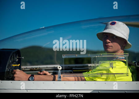 Civil Air Patrol Cadet, Jens Houck, waits for the wing-runner to signal that the air traffic pattern is clear for take-off in Springfield, Vt. Cadets attending the Northeast Region Glider Academy learn the standard hand signals used in glider ground operations. Stock Photo