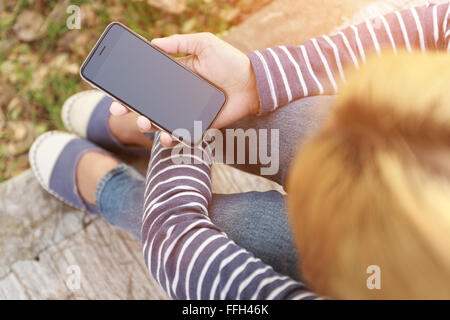 hipster female holding smart phone modern technology Stock Photo