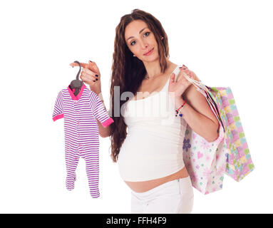 Portrait of a pretty middle aged pregnant woman with baby clothes and shopping bags over white background. Stock Photo