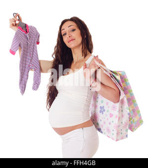 Portrait of a pretty pregnant woman with baby clothes and shopping bags over white background. Stock Photo