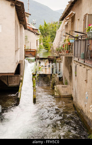 sights of a beautiful corner of an italian small village over the alps. example of rural architecture with a metal dam that chan Stock Photo