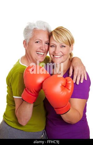 Two happy senior women with red boxing gloves Stock Photo