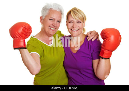 Two active senior women with red boxing gloves Stock Photo